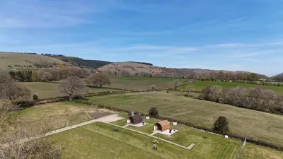 an aerial view of a house in a field at Mynd View Pods Ash in Craven Arms