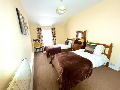 a hotel room with two beds and a window at Lion Royal Hotel, Rhayader in Rhayader
