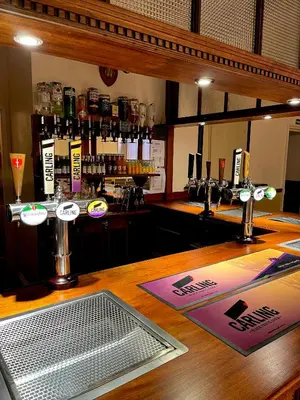 a bar with a wooden counter top with a bar at Lion Royal Hotel, Rhayader in Rhayader