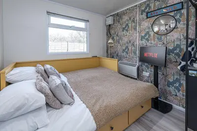 a bedroom with a bed and a sign on the wall at Alaya Airways in Dolgellau