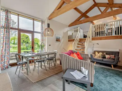 a living room with a table and chairs and a couch at 2 Bed in Hereford oc-42881 in Craswall