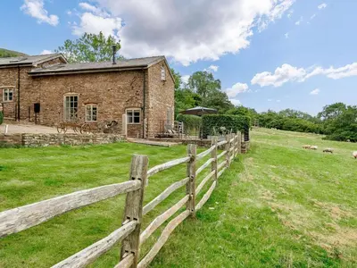a wooden fence in front of a house at 1 Bed in Hereford oc-42897 in Craswall