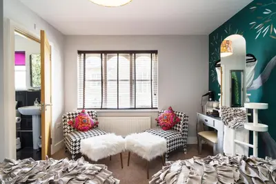 a room with two chairs and a table and a mirror at Maes Bach Boutique GUEST HOUSE TOWN CENTRE in Aberystwyth