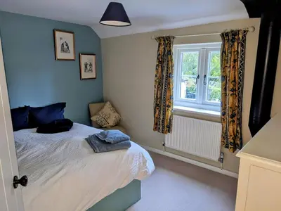 a bedroom with a bed and a window at The Byre in Yeaton