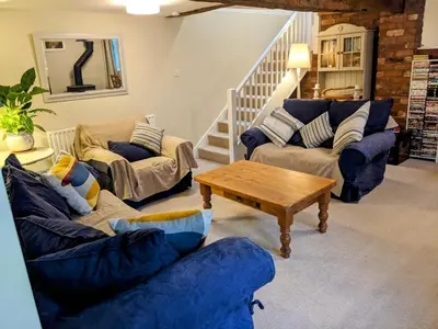 a living room with two couches and a table at The Byre in Yeaton