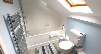 a bathroom with a toilet and a bath tub at The Byre in Yeaton