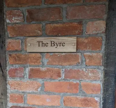 a sign on a brick wall that reads the hype at The Byre in Yeaton