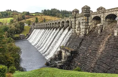 a large dam with a large waterfall at Dine & Rest, 1 bedroom apartment at little India in Llanrhaeadr-ym-Mochnant