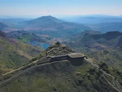 a train sitting on top of a mountain at Dine & Rest, 1 bedroom apartment at little India in Llanrhaeadr-ym-Mochnant