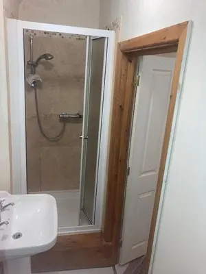 a bathroom with a shower and a sink at Dine & Rest, 1 bedroom apartment at little India in Llanrhaeadr-ym-Mochnant