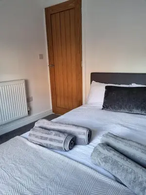 a bed with three towels laying on it at No 3 Waterloo Place in Welshpool