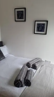 a bed with two pairs of towels on it at No 3 Waterloo Place in Welshpool