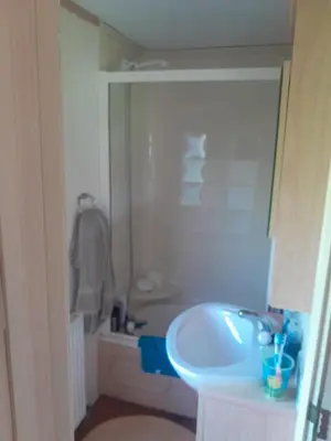 a bathroom with a sink and a bath tub at 254 Bryn y Mor in Tywyn