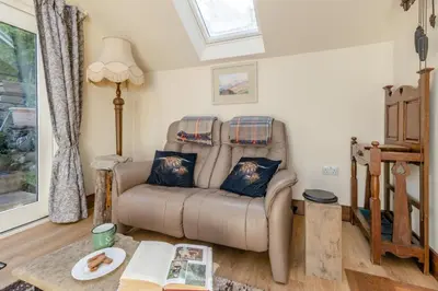 a living room with a couch and a table at 1 Bed in Llwyngwril oc-a31970 in Llwyngwril