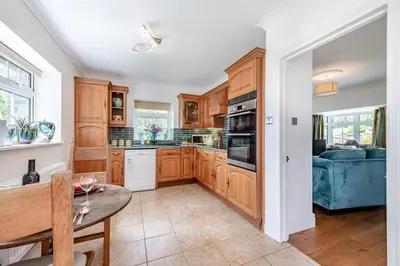 a kitchen with wooden cabinets and a blue couch at 1 Bed in Brynteg oc-g32079 in Llanwenog