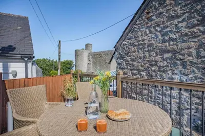 a table with two plates of food on a balcony at 1 Bed in Harlech oc-t32043 in Harlech