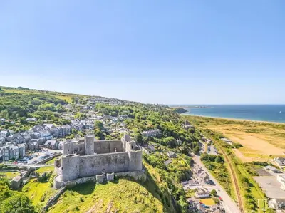 an old castle on a hill next to the ocean at 1 Bed in Harlech oc-t32043 in Harlech
