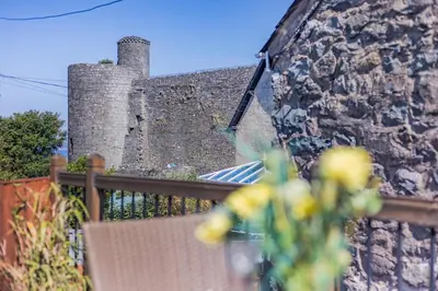 a brick wall with a chair and a building at 1 Bed in Harlech oc-t32043 in Harlech