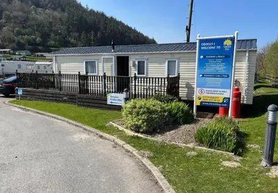a house with a sign in front of it at The Bay Pearl 2 Bedroom Elegant Pet Free Stay at Clarach in Aberystwyth
