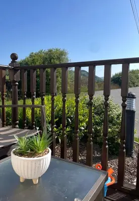 a balcony with a table with a plant on it at The Bay Pearl 2 Bedroom Elegant Pet Free Stay at Clarach in Aberystwyth