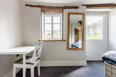 a room with a white desk and a mirror at 4 bedroom farmhouse Brecon Beacons in Talgarth