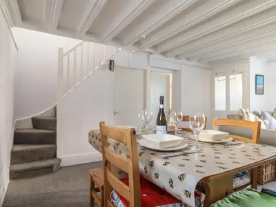 a dining room with a table with wine glasses at Glan Y Mor Borth in Aberystwyth