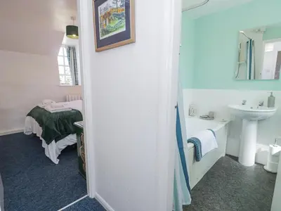 a bathroom with a sink and a toilet and a tub at Pen Y Bryn Bach in Harlech