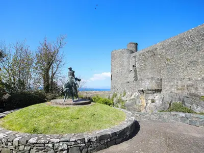 a statue of a man on a horse in front of a castle at Pen Y Bryn Bach in Harlech