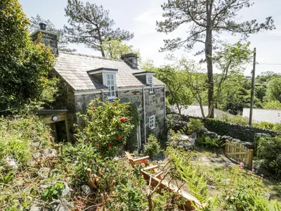 an old stone house with a garden at Pen Y Bryn Bach in Harlech