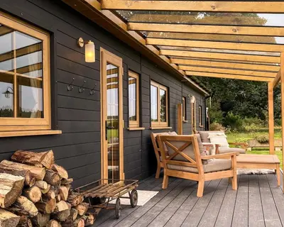 a deck with a chair and a bench on a house at The Meadow Snug in Baschurch