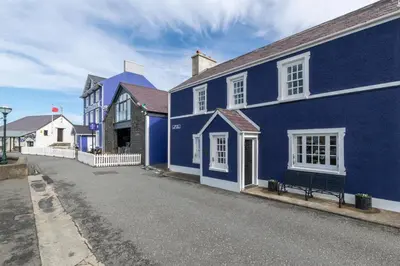 a blue house with a bench in front of it at 2 Bed in Aberaeron oc-bow173 in Aberaeron