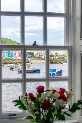 a window view of a harbor with boats in the water at 2 Bed in Aberaeron oc-bow173 in Aberaeron