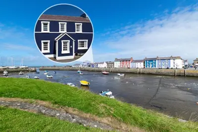 a house on a river with boats in the water at 2 Bed in Aberaeron oc-bow173 in Aberaeron