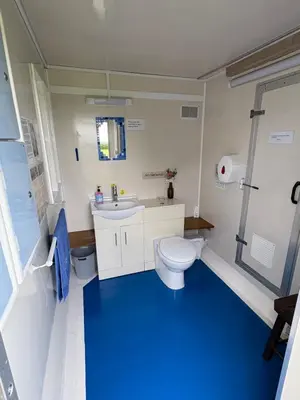 a bathroom with a white toilet and a sink at 5 Metre 'UNFURNISED' Bell Tent in Ball