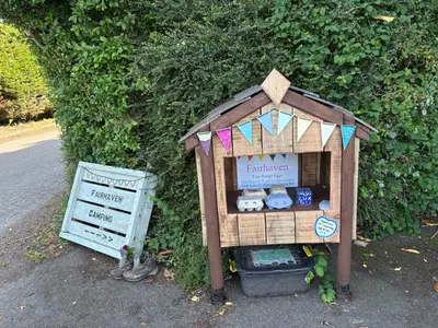 a small toy house sitting next to a bush at 5 Metre 'UNFURNISED' Bell Tent in Ball