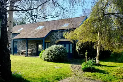 a stone house with a gambrel roof at Pretty barn conversion in seaside village in Llansantffraid