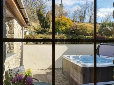 a view from a window of a hot tub on a patio at Y Dderwen Aberaeron in Llanarth
