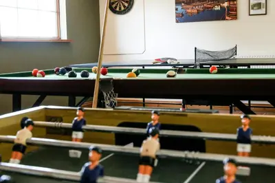 a group of children playing a game of pool at Yr Onnen Aberaeron in Llanarth