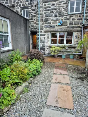 a stone house with a garden in front of it at Forden House in Dolgellau