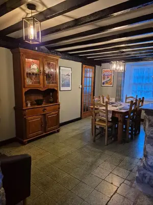 a dining room with a wooden table and chairs at Forden House in Dolgellau