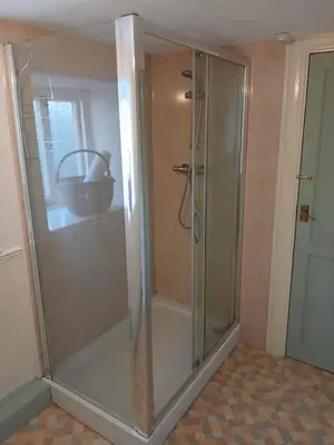 a shower with a glass door in a bathroom at Forden House in Dolgellau