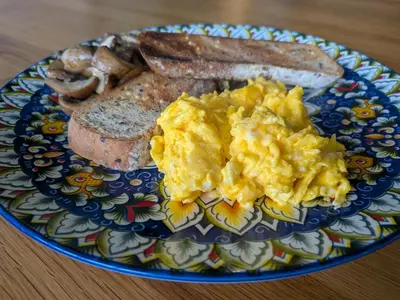 a plate of scrambled eggs and toast on a table at Aelybryn in Llangwyryfon