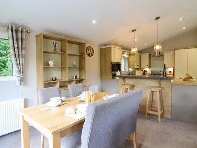 a kitchen and dining room with a wooden table and chairs at The Owlet in Llanidloes