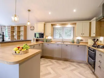 a kitchen with a bowl of fruit on a counter at The Owlet in Llanidloes