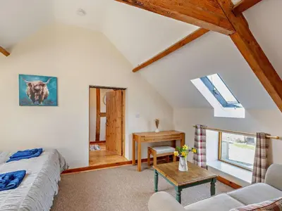 a attic room with a bed and a table at 2 Bed in Craven Arms oc-96046 in Tugford