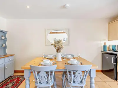 a kitchen with a wooden table and white chairs at 2 Bed in Craven Arms oc-96046 in Tugford
