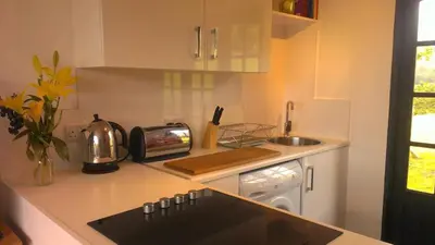 a kitchen with a counter top with a sink and a stove at Parkway Chalet - Pennal, Powys, Wales nr Aberdovey in Pennal