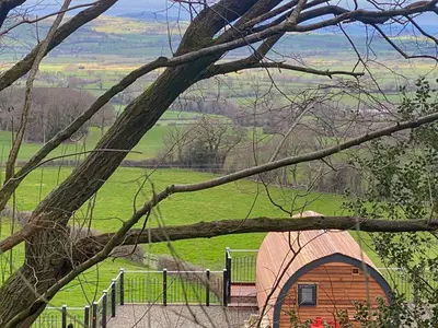 a small building in a field with a fence at Luna Holiday Pod - Uk48590 in Church Stretton