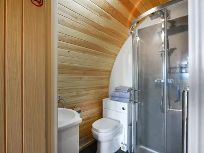 a bathroom with a toilet and a shower at Sunset Holiday Pod - Uk48592 in Church Stretton