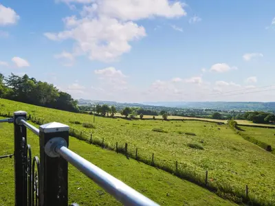 a view of a field of grass with a fence at Sunset Holiday Pod - Uk48592 in Church Stretton